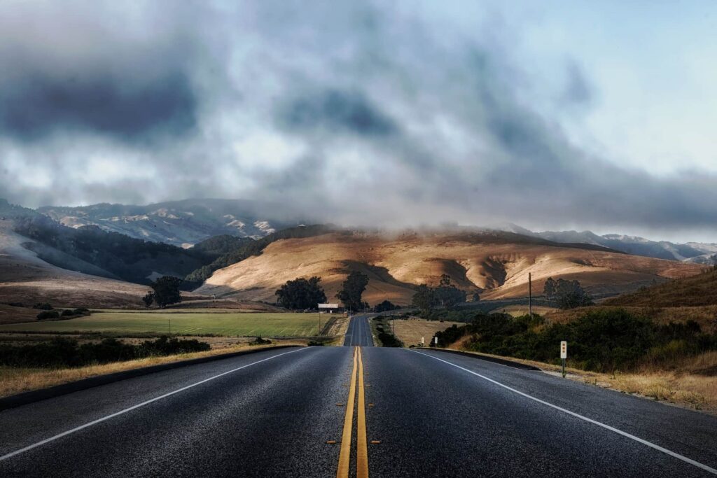 Paved road through field