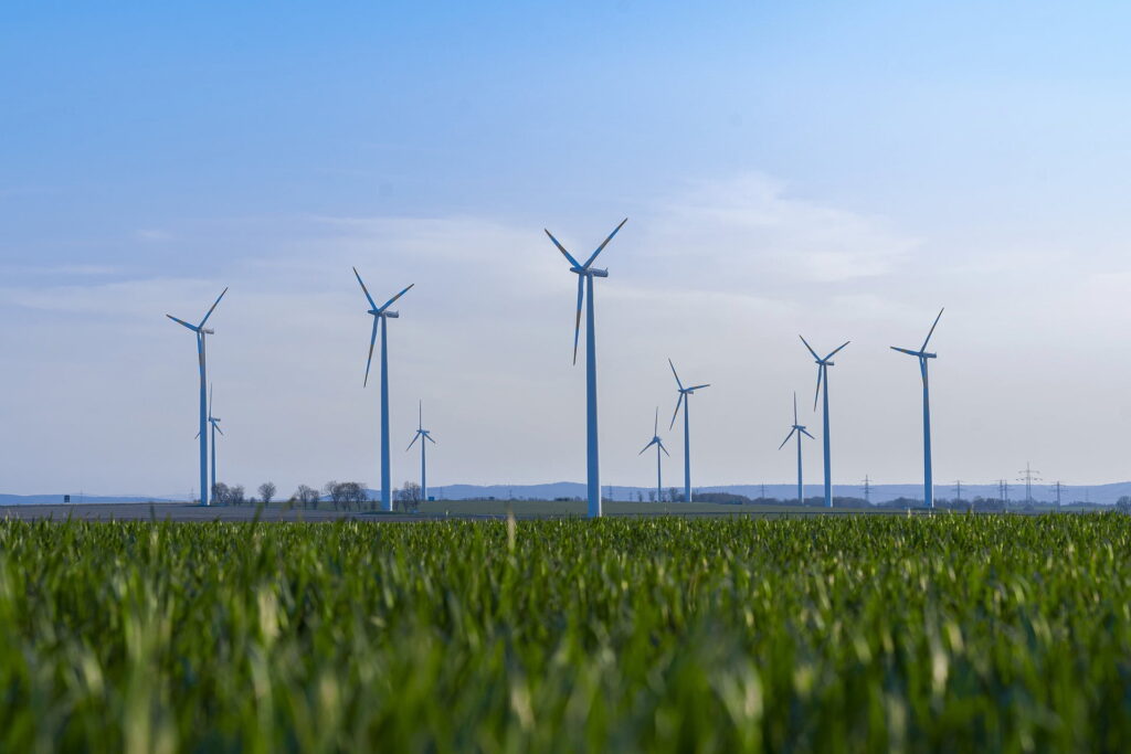 Wind turbines standing on field